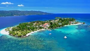 Samana Bay waterfront with sailboats and turquoise water.